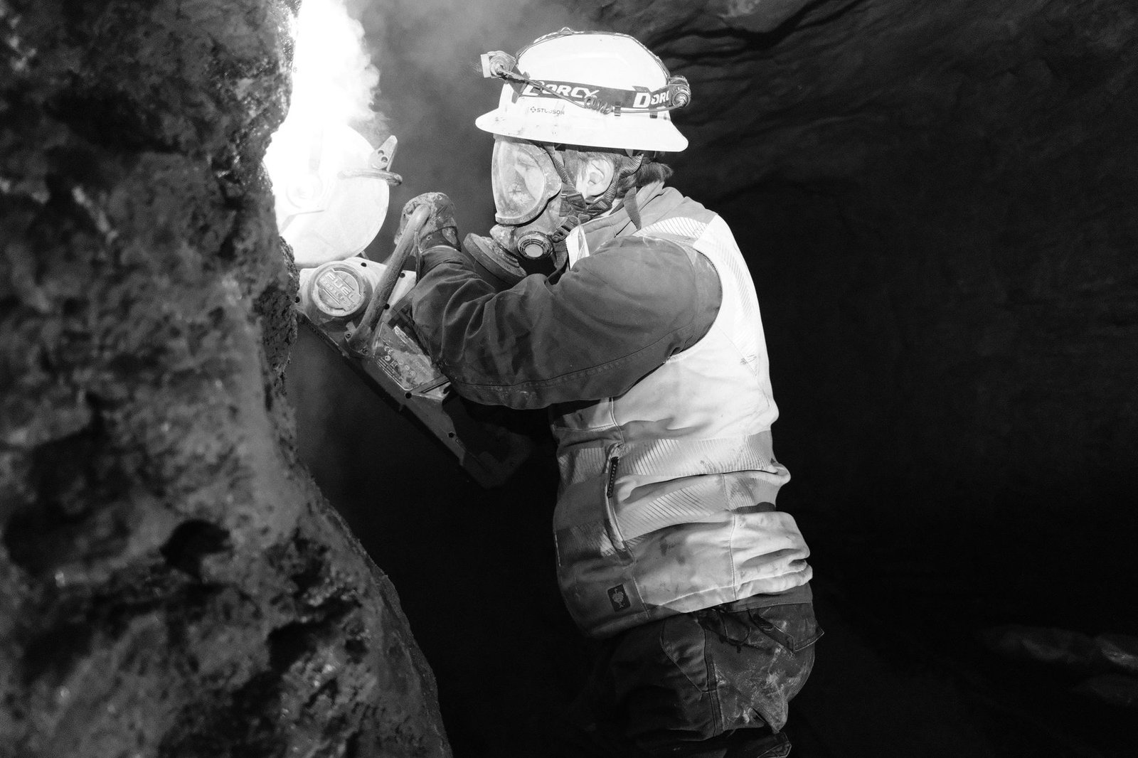 Geologist cutting an underground rock sample with a saw
